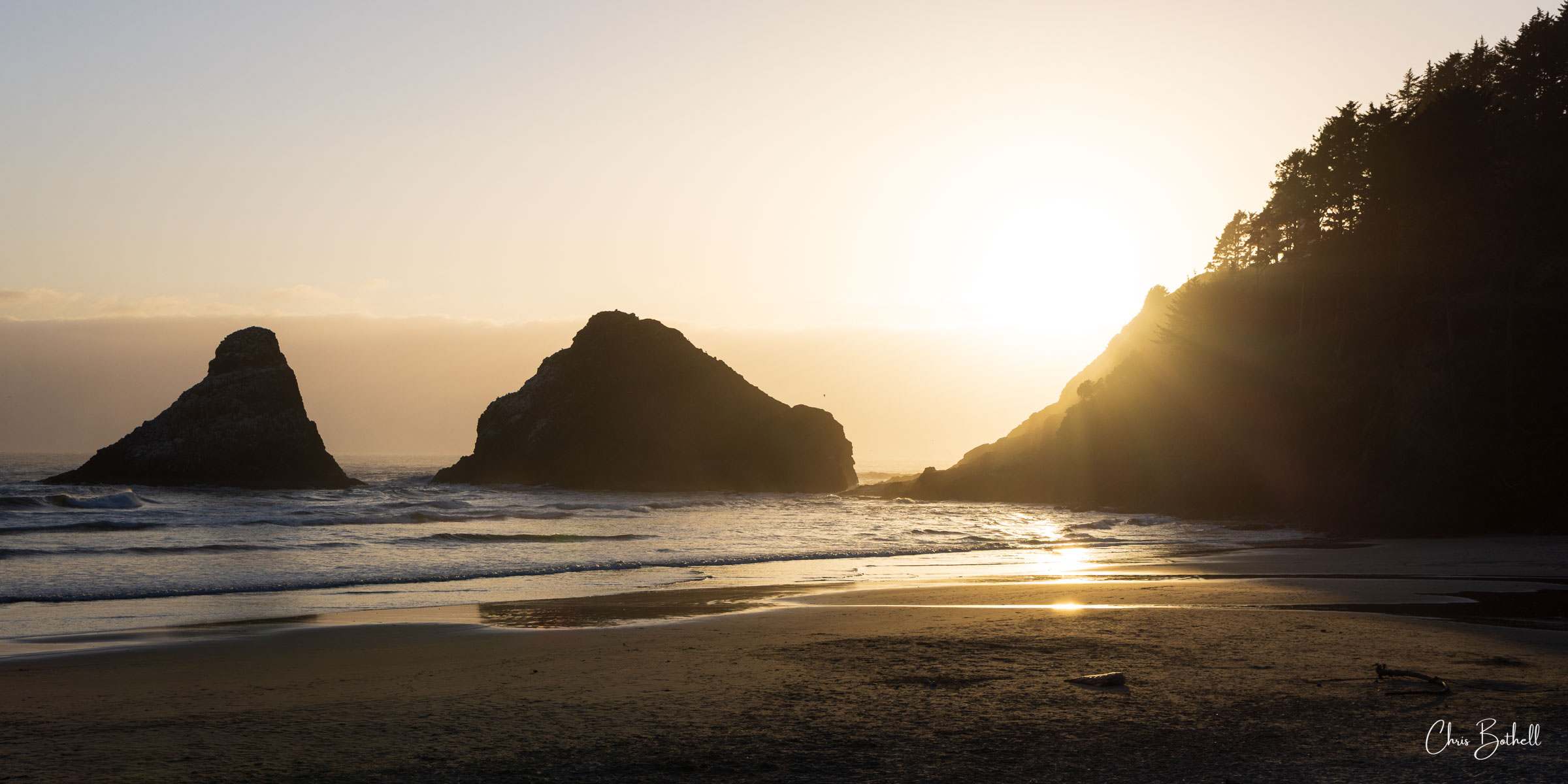 Beach Glow A gentle haze softens the distant waters as golden light washes over the rugged silhouette of the Oregon coast.